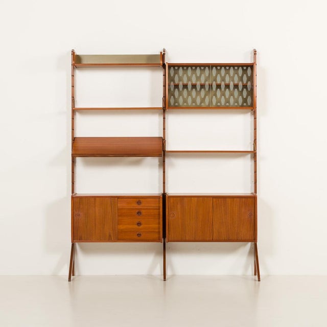 This fully renovated scandinavian freestanding wall unit in teak comes from norway from the 1960s. It is a completely...