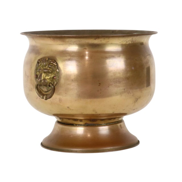 A charming vintage classic flower pot, cache-pot, or jardinière made of brass, featuring lion-head handles on both sides;...