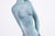 A graceful figurative sculpture by Joyce Gottlieb, Untitled (Standing Turquoise Nude), circa 1990, captures a stylized...