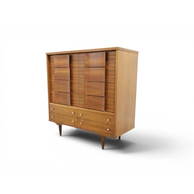 A handsome highboy dresser from Johnson Carper's iconic "Fashion Trend" line, produced in Roanoke, Virginia during the...