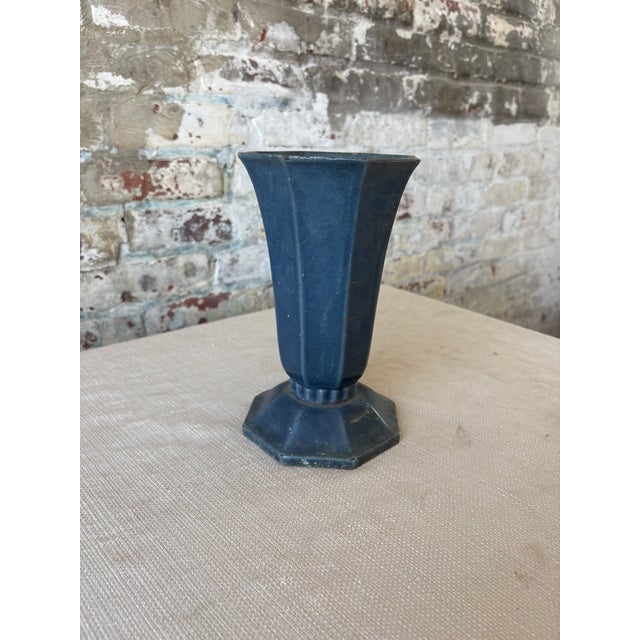 A sophisticated vintage metal vase with elegant Art Deco styling and architectural presence. Designed with a faceted...