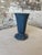 A sophisticated vintage metal vase with elegant Art Deco styling and architectural presence. Designed with a faceted...
