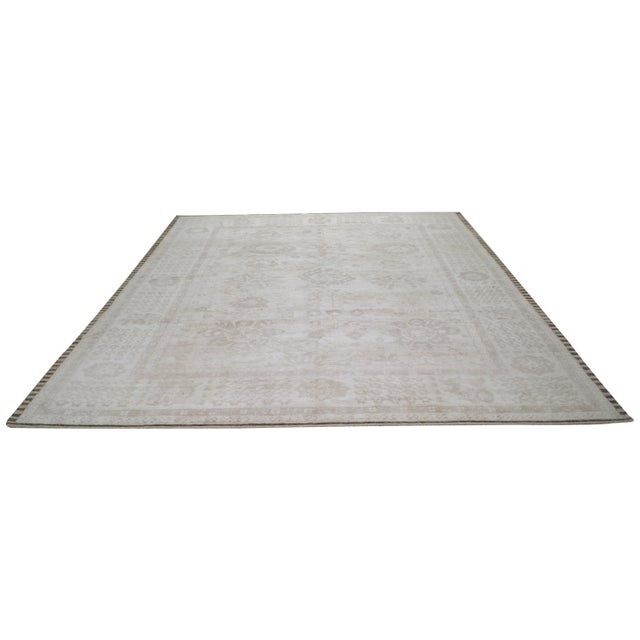 Hand-knotted with care using traditional rug making techniques, this wool rug blends timeless craftsmanship with a modern...