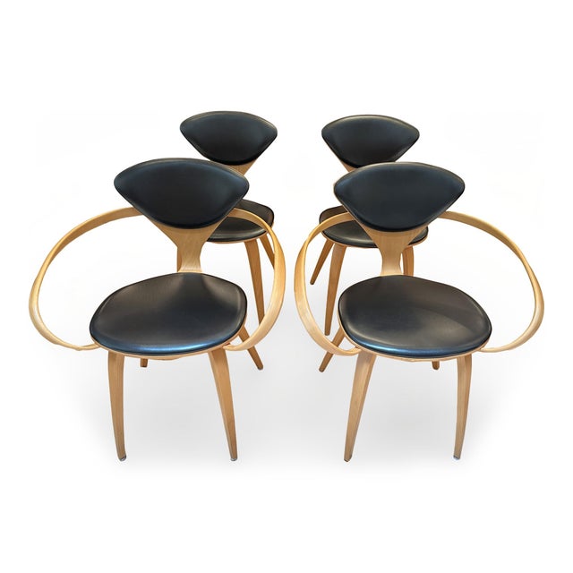 Set of four walnut dining chairs by Norman Cherner. Originally designed by Cherner for Plycraft in the 1950s, these...