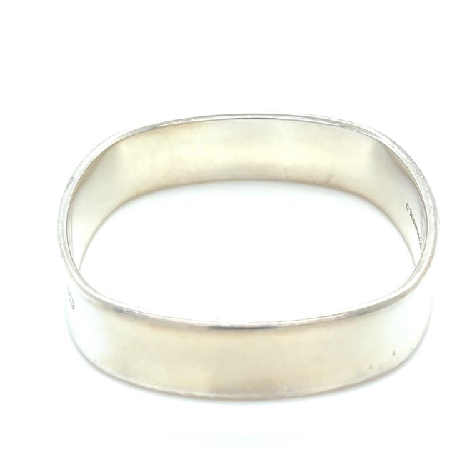 A distinctive Tiffany & Co. 1837 Collection bangle crafted in sterling silver, featuring a contemporary square cushion...