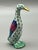 Crafted in Hungary, this charming little goose features intricate scale-like painting, accented with rich hand-applied...