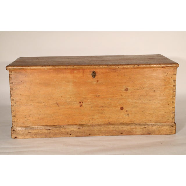 English pine trunk, circa 1900. With a single board rectangular top with rounded front and side edges, front and sides...