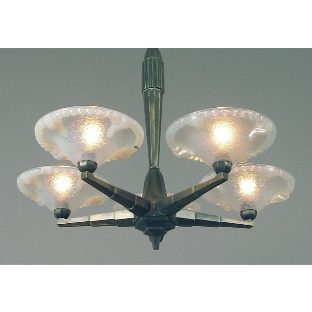 Offering an especially well-designed French Art Deco chandelier, the spare geometric design so appropriate to its period....