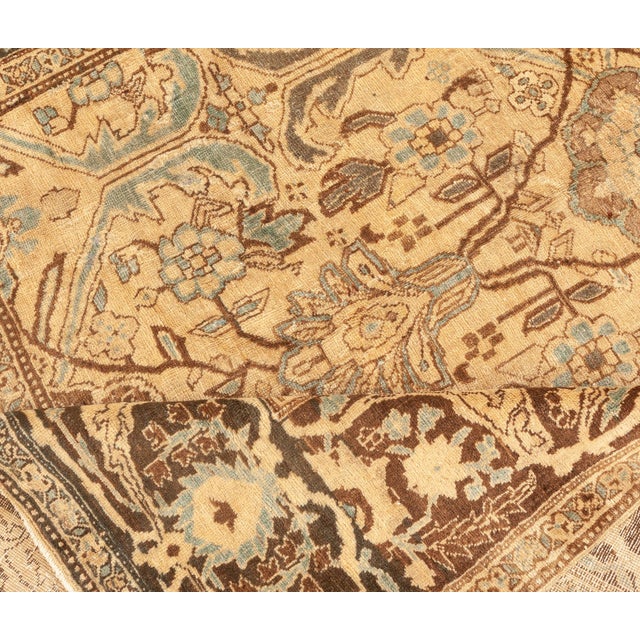 This turn of the century antique Persian Bidjar rug features an elaborate all-over design of floral abstractions and...