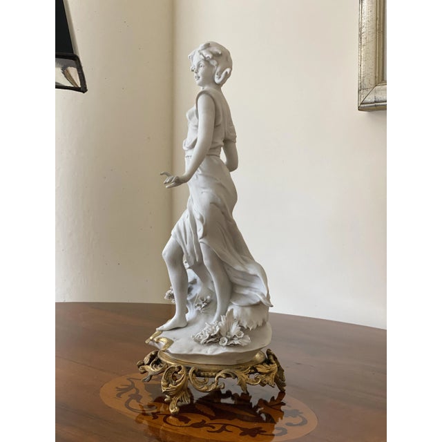 Sculptural maiden molded in fine and rare Biscuit porcelain on a gilded bronze base, signed by Costantino Barbella (Italy...