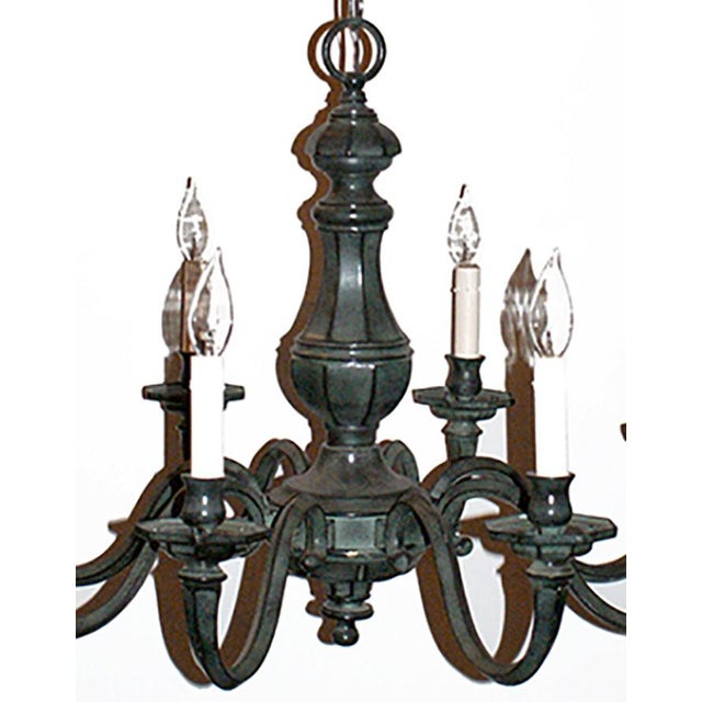 Eight arm chandelier with octagonal candle cups. Verdigris finish.