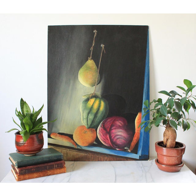 Vintage unframed moody still life painting on board. Features a hanging yellow pear, a green squash, an orange, and a dark...