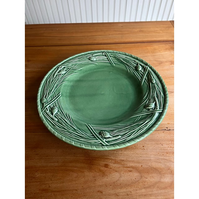 Gorgeous, hard to find discontinued Bordallo Pinheiro “Pine Green” Chop Plate. This 12” size Majolica plate is a wonderful...