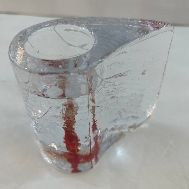 Thick texted glass candle holder with red mix inside during the blowing and molding process. It maintains its original...
