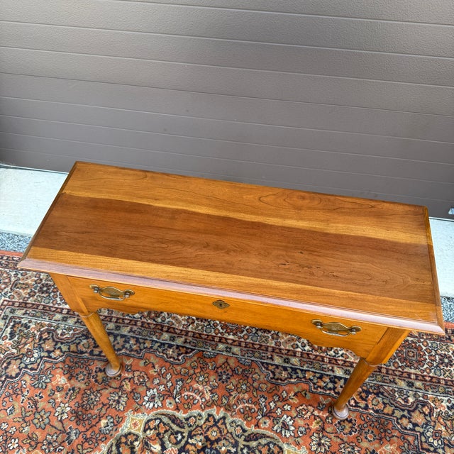 A vintage Statton Trutype Americana Traditional solid cherry console or hall table having one dovetailed drawer with...