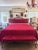 Striking vintage Hollywood Regency king-size bed with its matching tufted bench, upholstered in rich raspberry-red velvet...
