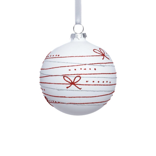 Add a whimsical yet refined touch to your seasonal décor with these matte glass ball ornaments, detailed with a charming...