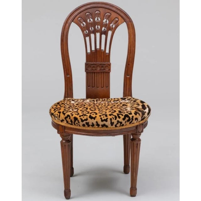 34 3/4 × 19 x 19 in., seat height 16 3/4 in. Old repairs to the backrest with a loss of one bell-flower. Age splits to the...