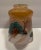 A 1930s hand painted glass ceiling light shade with a country scene of trees, hills and cabins. Unsigned. The width of the...