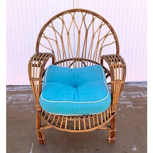 This is a stunning vintage Boho rattan lounge chair. Solid and sturdy, although the front left leg bends a little....