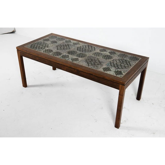 Rosewood coffee table with ceramic tiles inlaid to top. Signed to corner of tiles. Denmark, circa 1970s. Dimensions: H 20"...