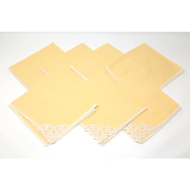 A set of seven yellow linen napkins, with white lace trim. Excellent condition. Each approximately 15" x 15"
