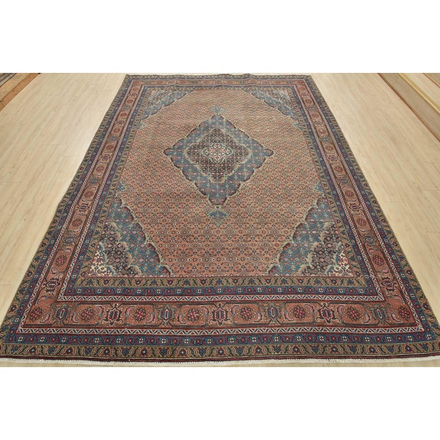 This authentic vintage traditional Tabriz rug is hand-knotted with fine wool and natural dyes. This oriental rug features...