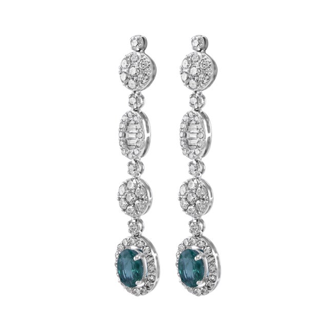 Beautiful natural oval emerald and diamonds drop earrings. 5.65 carats total gemstone weight. 2 oval emeralds, 3.68...