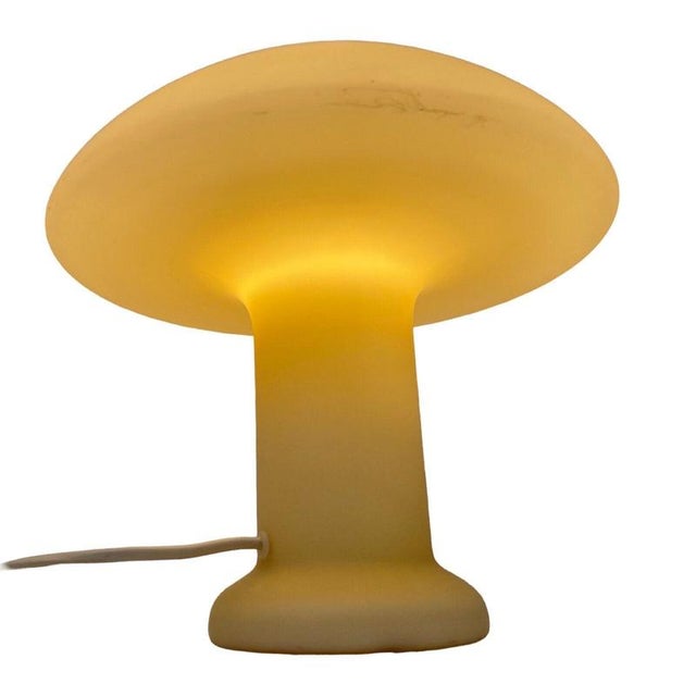 Oof white glass lamp made by the German company Hustadt Leuchten in the 1980’s. It can give a somewhat more yellow glow...