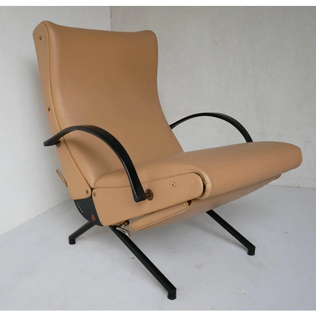 "P40" armchair with metal frame, elastic strap padding, and original faux leather upholstery. First series with round legs...