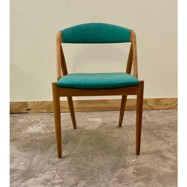 This set of four dining room chairs, model 31, Attributed to the renowned Kai Kristiansen around the 1960s, showcases the...