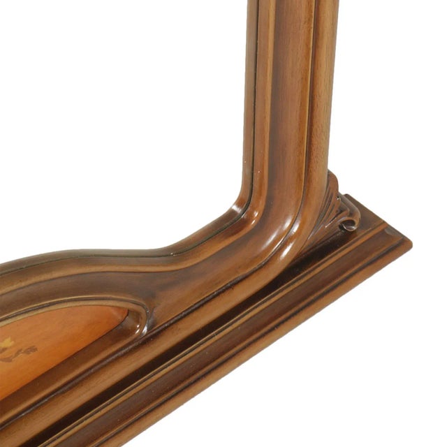 This is a 1930s Italian Gothic style wall mirror in wax polished carved and inlay walnut.