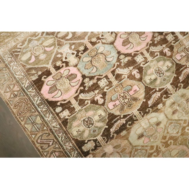 A 3rd quarter of the 20th century Persian Rug in browns and pink