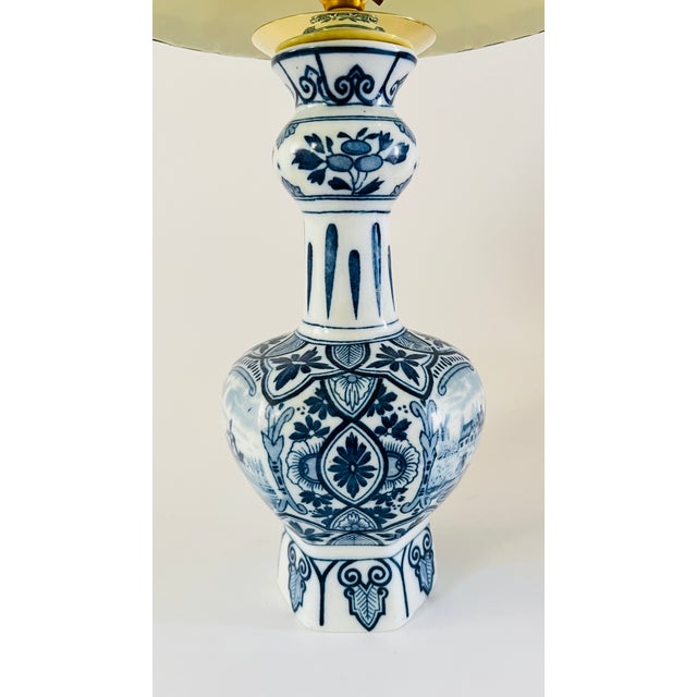 A 20th century Delft vase lamp, in a classic garlic neck shape. Decorated in blue and white with two different prints: two...