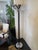 Art Deco Style Floor Lamps in black lacquer with nickel details on base and shade. Half-round frosted glass inserts emit...