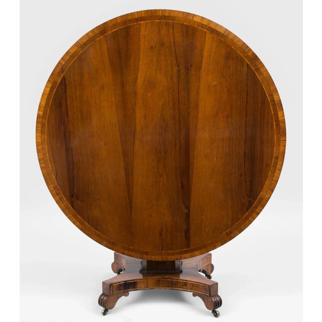 Boldly figured rosewood tilt-top centre table, the circular top with three different widths of crossbanding, the frieze...