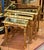 Elegant set of three French style nesting tables featuring sophisticated mirrored tops that beautifully reflect the...
