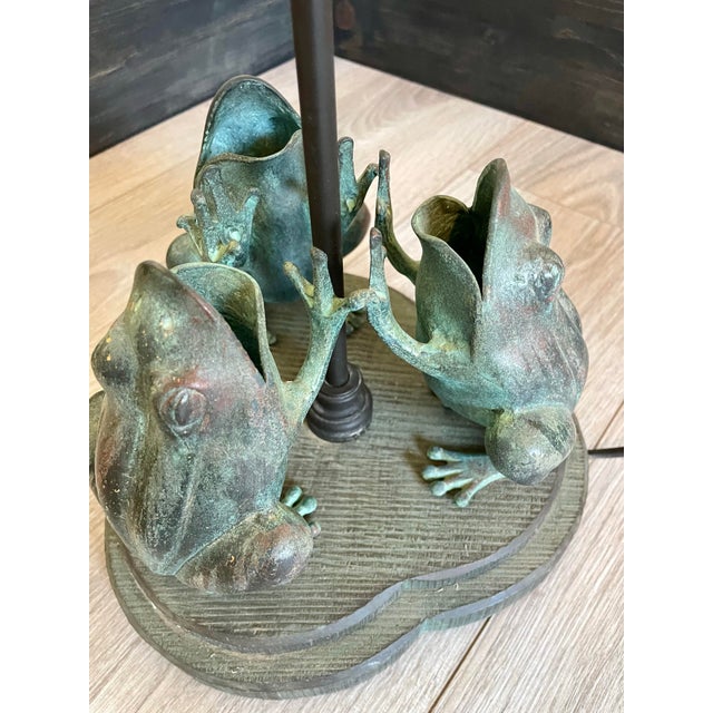 Add a touch of whimsical elegance to your space with this stunning vintage Frederick Cooper "Symphony of Frogs" table...