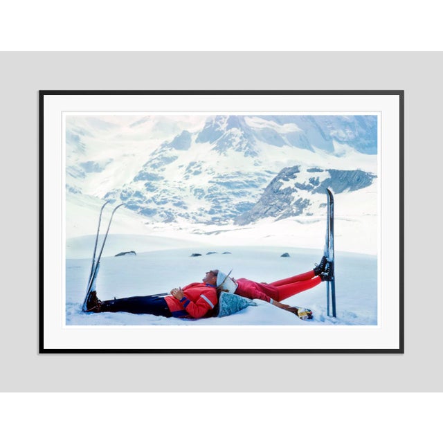 Ski Mirror by Toni Frissell Two skiers lie back to back at the top of a mountain in Zermatt, Switzerland, 1961. (Toni...