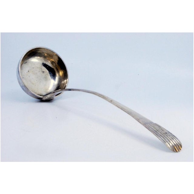 Silver Soup Ladle with Embossed Handle, in Very Good conditions. Designed 1890 to 1919 This piece has an attribution mark,...