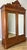 This impressive Antique French wardrobe is a beautifully crafted piece featuring a rich mahogany finish, elegant mirrored...