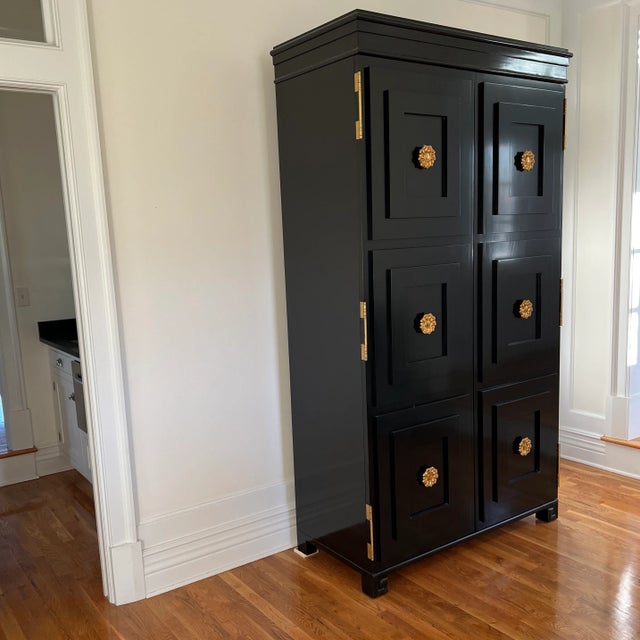 Mirror back interior, glass upper shelves, lockable bottle cabinet below The Tuxedo Tall Cabinet was inspired by a vintage...