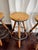CB2 Set of 4 Industrial Tripod Legs Cb2 Acacia Wood Round Seat Adjustable Counter Stools With Wrought Metal Hardware For Sale - Image 4 of 12