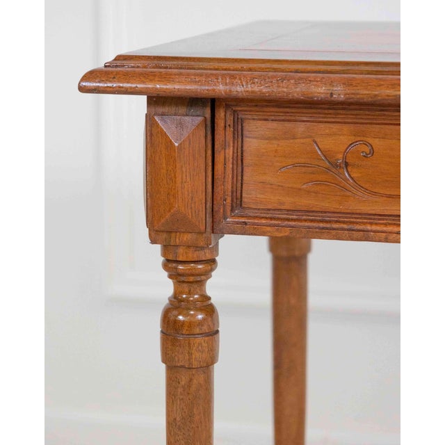 A refined Italian 19th century writing table, crafted in solid walnut and distinguished by its elegant simplicity and...