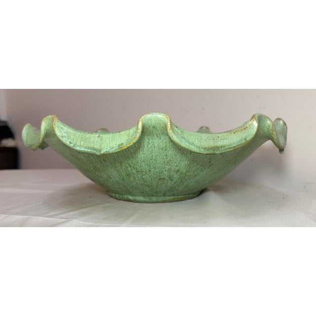 This Large antique handmade green glaze centerpiece pottery bowl from North Carolina is a unique and decorative piece of...