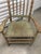 Charming vintage American Primitive-style armchair featuring a tall spindle back, turned posts and stretchers, sculpted...