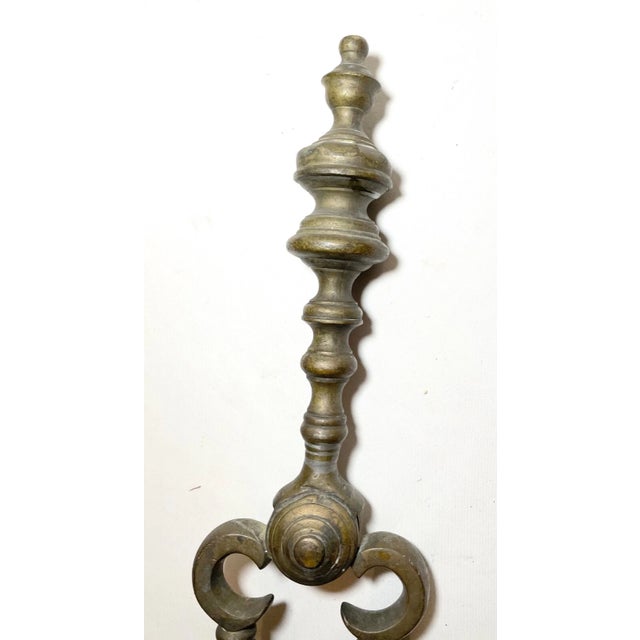 Up for sale is a nice pair of rare antique 18th century wrought iron and brass English fireplace tongs. The arms are...