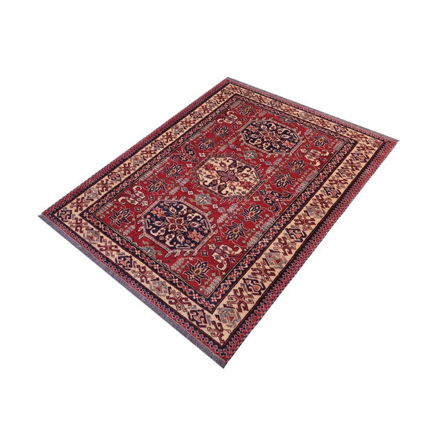 Enhance your home with this exquisite hand-knotted Super Kazak rug, crafted from fine hand-spun wool and dyed with all-...