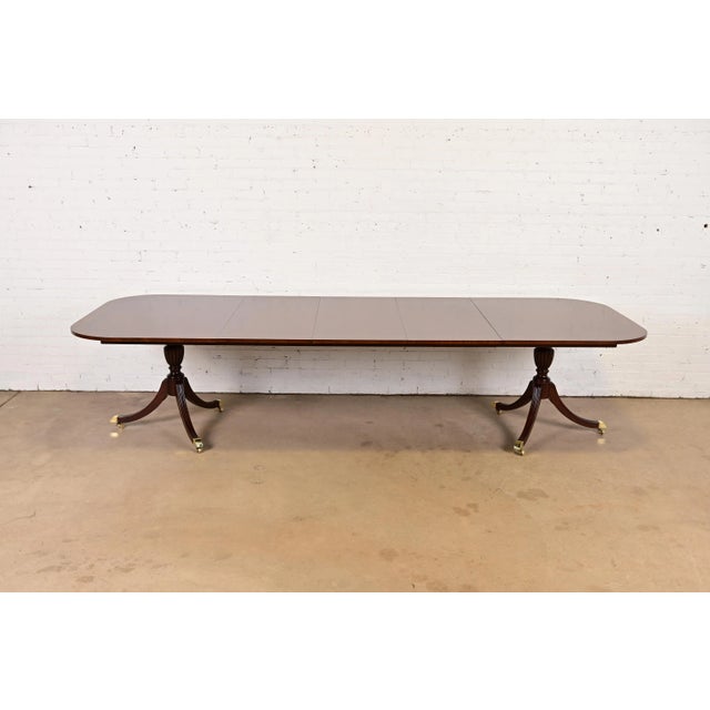 An exceptional Georgian or Regency style double pedestal extension dining table By Councill Furniture USA, Circa 1980s...