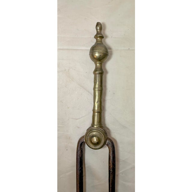 Up for sale is a nice pair of rare antique 18th century wrought iron and brass English fireplace tongs. The arms are...